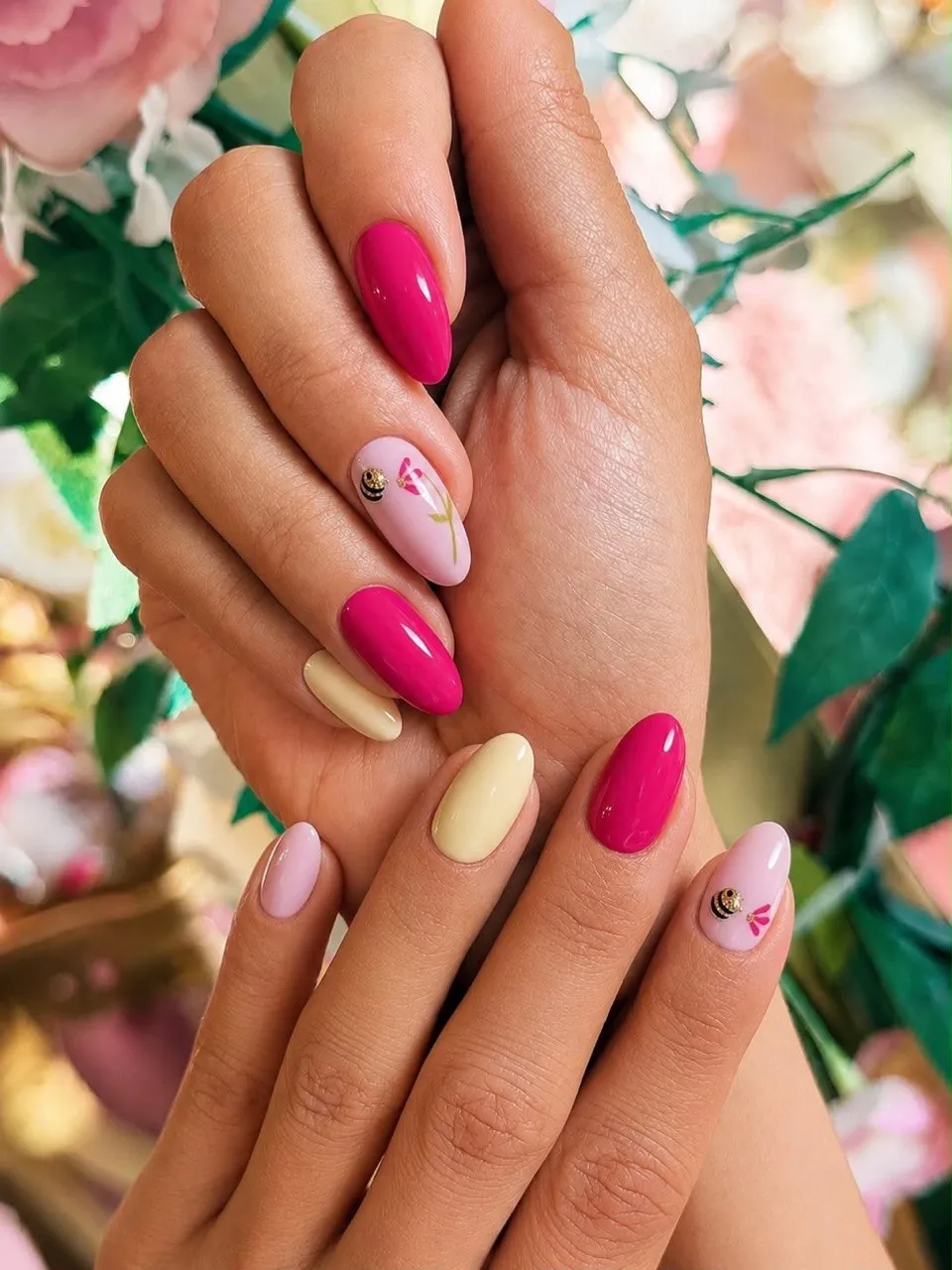 Pink and lemon nails with a hand-painted flower and a tiny gold bee